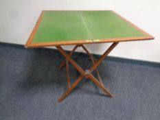 A folding oak campaign style baise topped card table