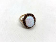 A 9ct gold opal and garnet ring, size N. CONDITION REPORT: 3.