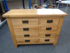 A contemporary oak eight drawer chest