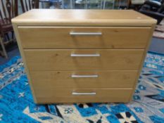 A contemporary four drawer chest in an oak finish