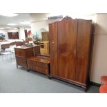 A late Edwardian stained walnut three piece bedroom suite : single door wardrobe,