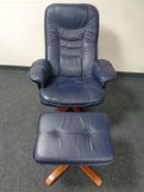 A blue leather manual reclining swivel armchair with footstool