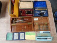 A tray of assorted cased medical instruments, Everett syringes, hypodermic needles,