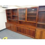 A mid 20th century Danish two piece display unit fitted cupboards and drawers