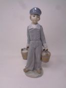 A Lladro figure of a Dutch boy with baskets, 4811.