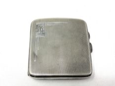 A silver cigarette case with engine turned decoration CONDITION REPORT: 97g