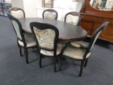 An Italian style shaped pedestal dining table together with a set of six chairs upholstered in map