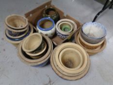 A large quantity of glazed pottery plant pots
