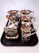 A tray containing five Masons Mandalay jugs together with a matching mantel clock.