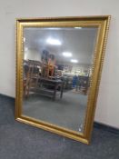 A contemporary gilt framed bevel edged overmantel mirror