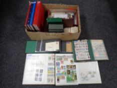 A box containing a quantity of stamp albums containing world stamps to include Australia,