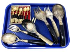 A set of Thai brass forks and spoons together with a quantity of Thai white metal salad servers