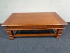 A rectangular stained pine two tier coffee table fitted a drawer