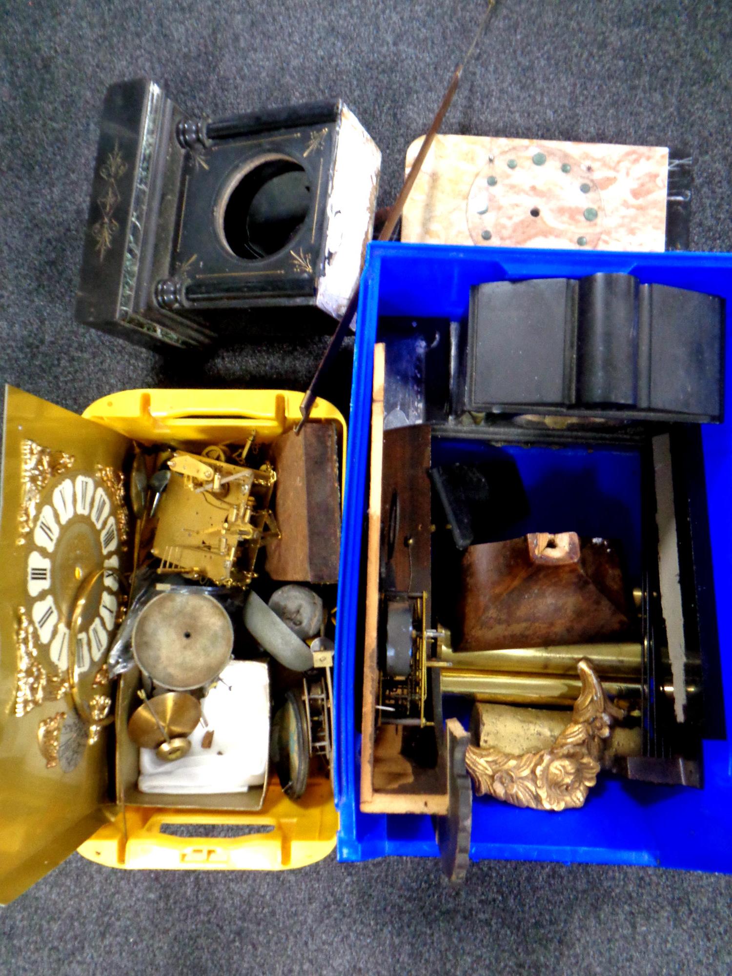 Two plastic crates of clock weights, movements, faces,