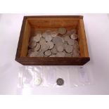 A plywood box containing a quantity of Swiss coins.