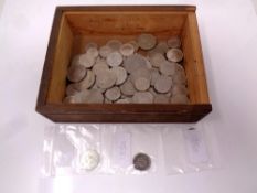 A plywood box containing a quantity of Swiss coins.
