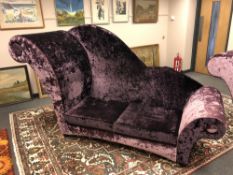 An oversized chaise longue upholstered in purple crushed velvet.