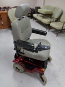 A Rio Rascal power assisted wheelchair with charger and seat restraint