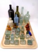 A tray of antique and later glass and ceramic bottles