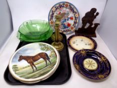 A tray containing a 19th century cast iron door stop with a pair of antique brass candlesticks,