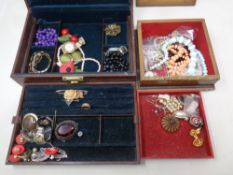 Two jewelry boxes, one wood and one leather containing a quantity of assorted costume jewelry,