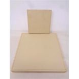 Two Rolex cream stitched leather watch display trays, 15 cm x 15 cm and 25 cm x 25 cm,