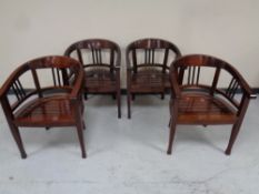 A set of four contemporary low backed wooden armchairs