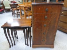 An audio cabinet in the form of a chest together with a nest of three tables in a mahogany finish