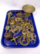 A tray containing an antique wooden handled corkscrew together with a quantity of brass ware to