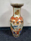 An oriental style porcelain vase decorated with flowers and geishas.