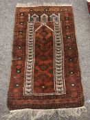 An Afghan prayer rug, 135 cm x 82 cm.