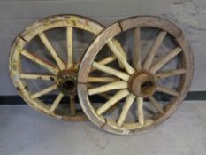 Two wooden cart wheels