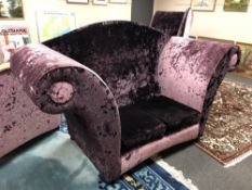 An oversized two seater settee in purple crushed velvet.