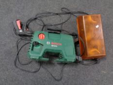 A Bosch pressure washer with hose and nozzle,