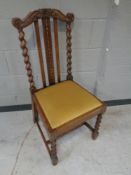 An Edwardian oak barley twist hall chair