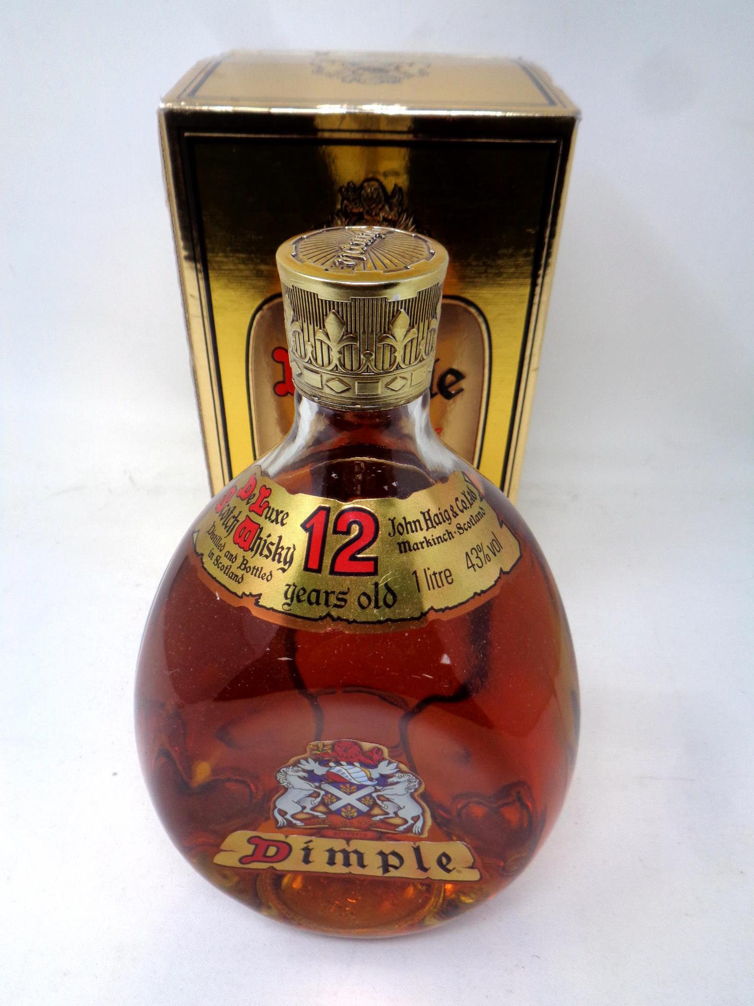 A 1 litre bottle of Dimple De Luxe Scotch whisky 12 years old in presentation box