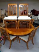 A circular Regency style pedestal dining table in a high gloss mahogany finish together with a set