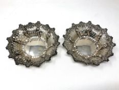 A pair of ornate pierced silver dishes,
