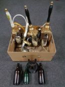 A box containing brewery items to include five porcelain handled hand-pulled beer pumps,