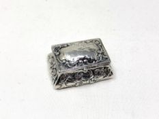 A small embossed silver pill box, width 4.