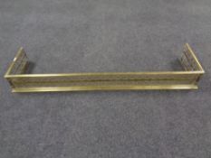 A Victorian brass fret work fender.