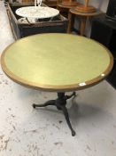 A circular oak inset paneled bar table on a cast iron pedestal base