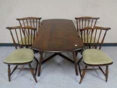 An Ercol elm and beech drop leaf table together with a set of four chairs