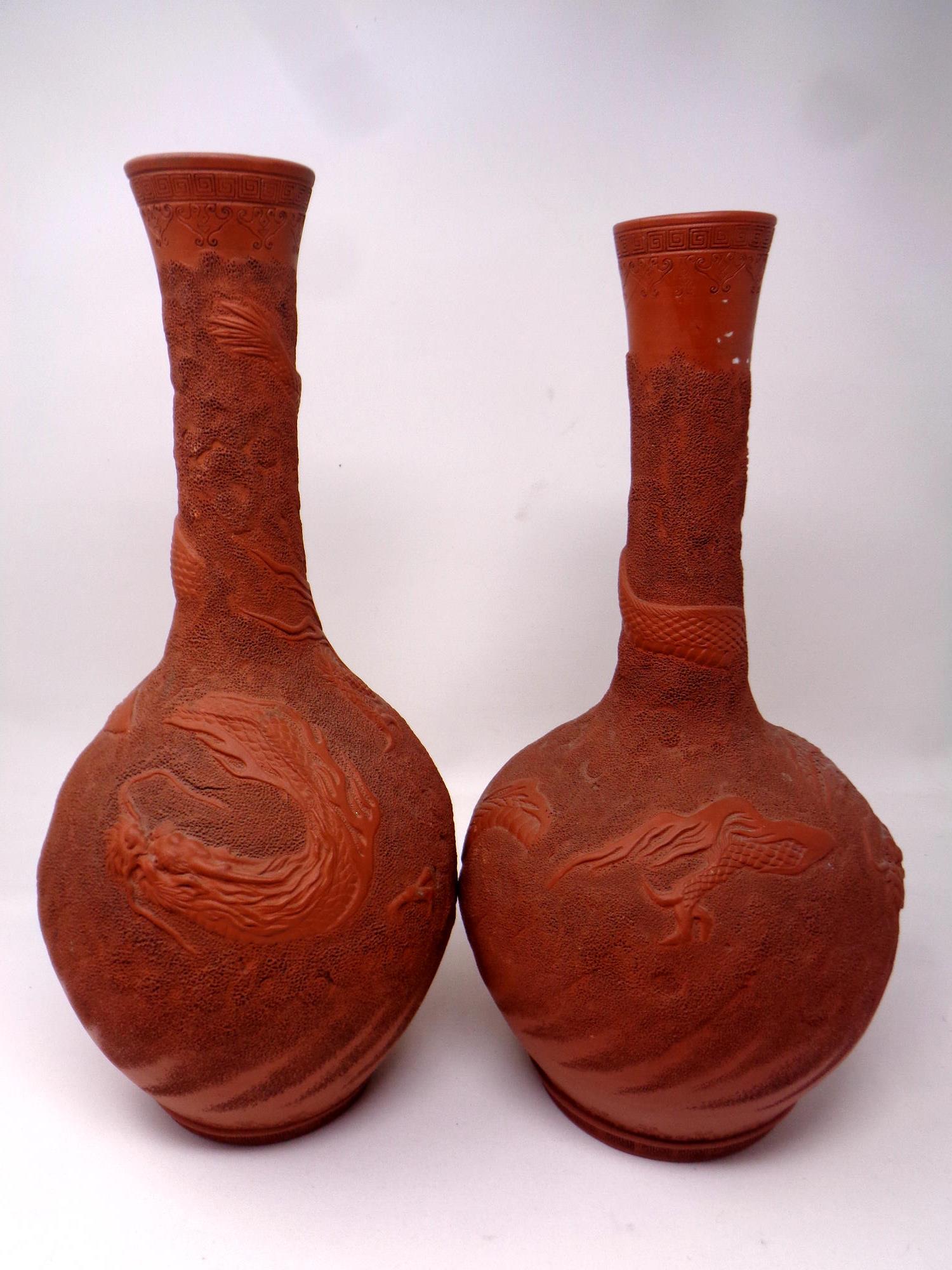 Two Chinese red clay vases, with dragon decoration.