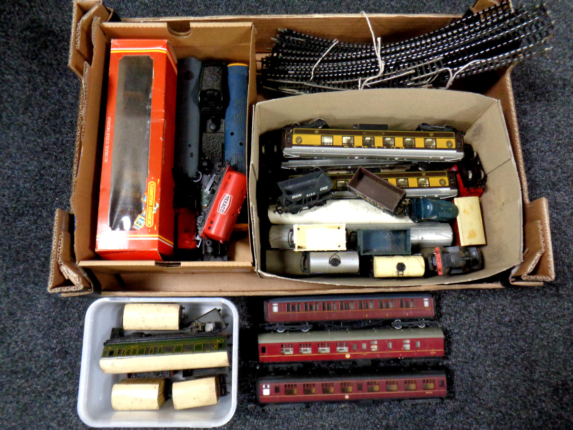 A box containing a large quantity of assorted tin plate and plastic rolling stock to include