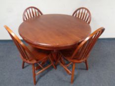 A circular pedestal extending kitchen table together with a set of four railback chairs