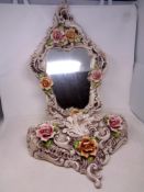 A Capodimonte flower encrusted china framed wall mirror with matching wall shelf