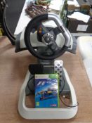 An Xbox 360 steering wheel with foot pedals together with Formula 1 2012 game