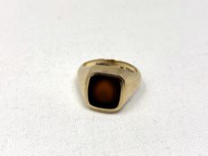 A 9ct gold signet ring inset with red stone, size K. CONDITION REPORT: 7.