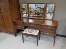 A Stag Minstrel five drawer knee hole dressing chest with triple mirror and stool